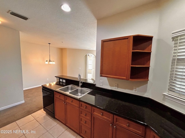 kitchen with light tile patterned floors, dark stone countertops, dishwasher, pendant lighting, and sink