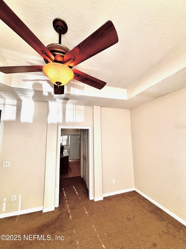 carpeted spare room featuring a textured ceiling