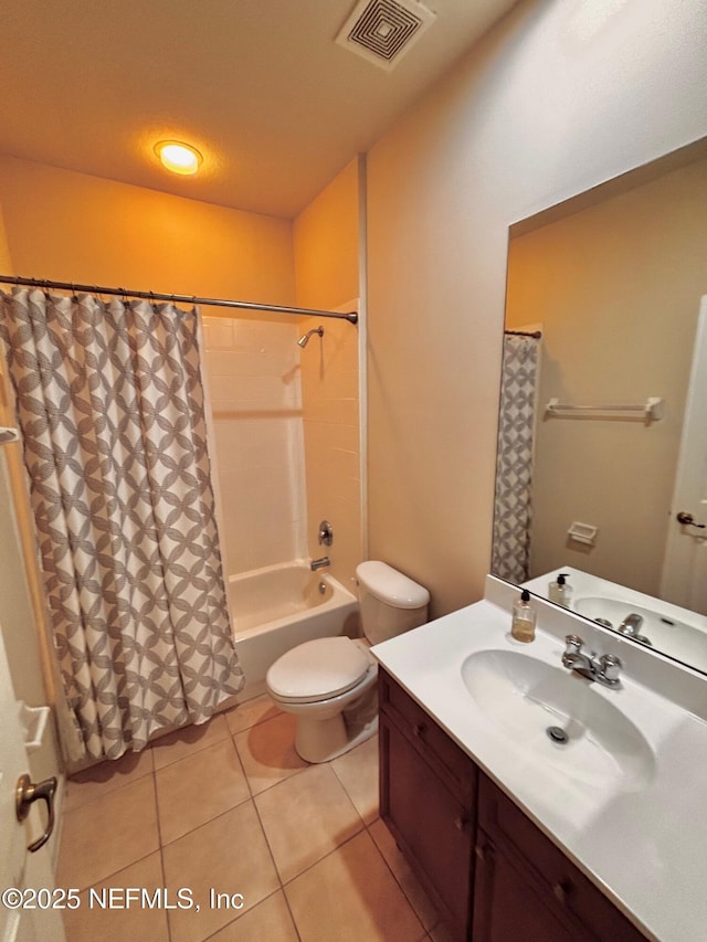 full bathroom featuring shower / bath combo with shower curtain, tile patterned floors, vanity, and toilet