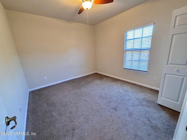 unfurnished room featuring dark colored carpet and ceiling fan