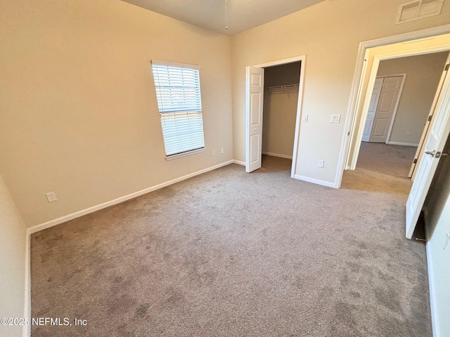 unfurnished bedroom featuring a closet and carpet flooring