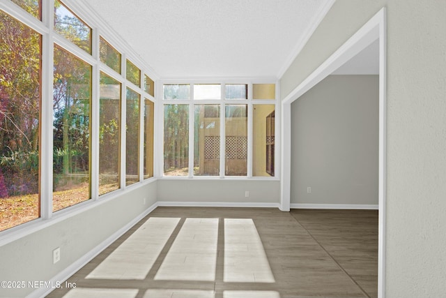 unfurnished sunroom featuring plenty of natural light