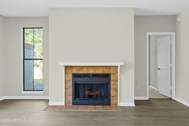 unfurnished living room with a fireplace and wood-type flooring