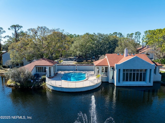 back of property featuring a water view