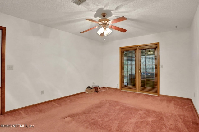 empty room with ceiling fan, carpet floors, and a textured ceiling