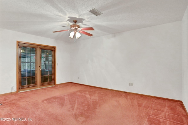 unfurnished room with ceiling fan, a textured ceiling, and carpet flooring