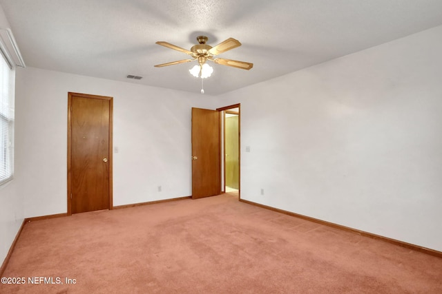 unfurnished room with light colored carpet and ceiling fan