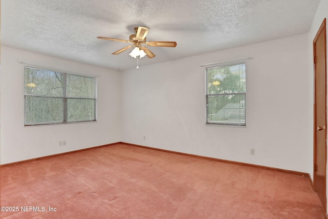 carpeted empty room with a textured ceiling and ceiling fan