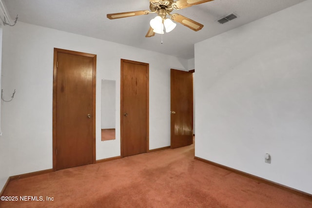 unfurnished bedroom featuring light carpet and ceiling fan