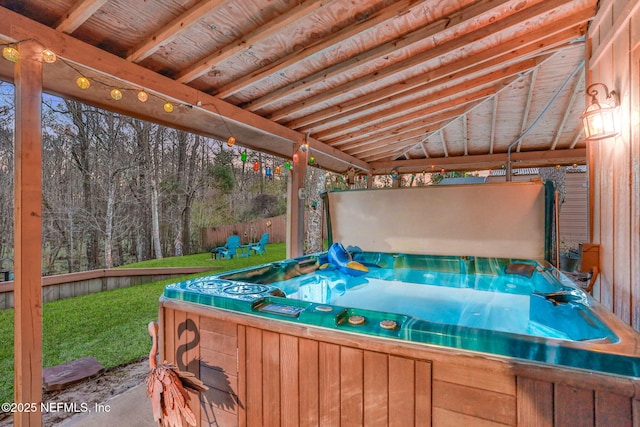 wooden terrace featuring a yard, a gazebo, and a hot tub