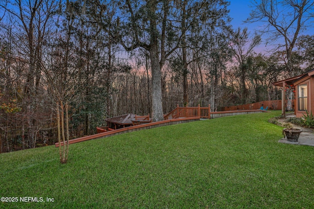 yard at dusk featuring an outdoor fire pit