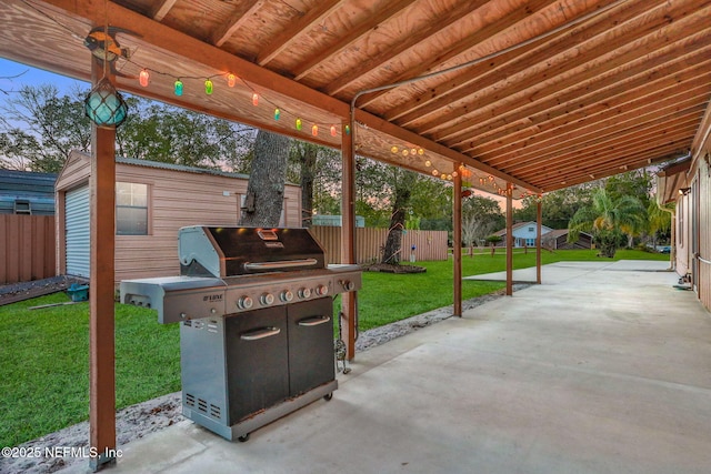 view of patio / terrace with area for grilling and an outbuilding