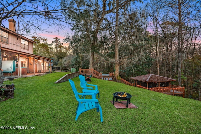 yard at dusk with an outdoor fire pit