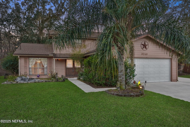 view of front of home featuring a garage and a front lawn