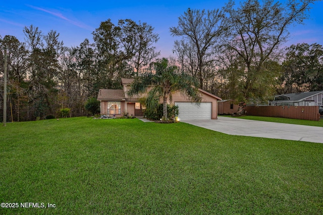 view of front facade with a garage and a lawn