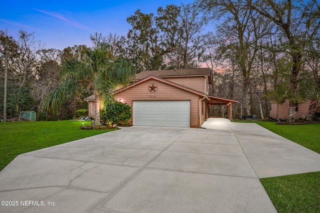 view of front facade with a garage, a lawn, and a carport