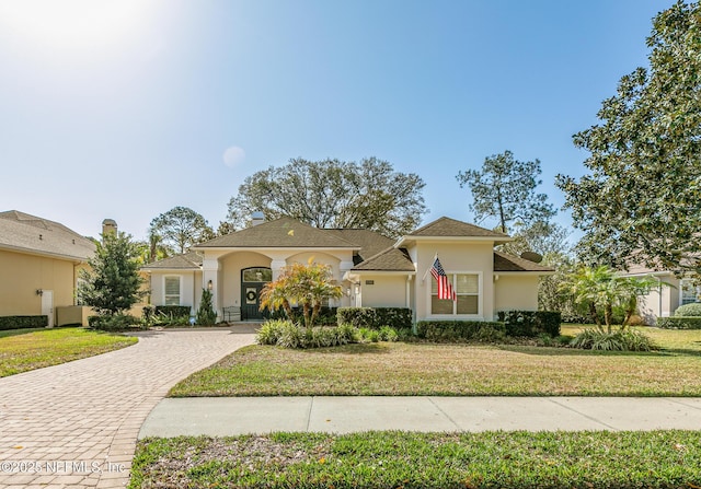 mediterranean / spanish home featuring a front yard