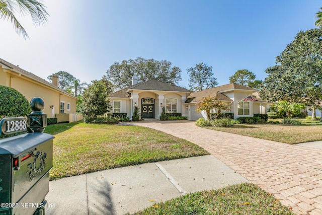 view of front of property with a garage and a front yard