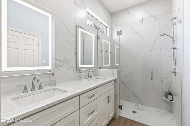 bathroom featuring vanity, wood-type flooring, and walk in shower