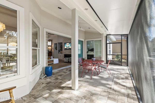 sunroom / solarium featuring a fireplace