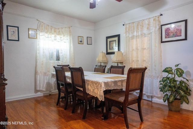 dining area with hardwood / wood-style flooring and ceiling fan