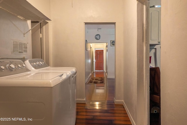 washroom with dark wood-type flooring and washing machine and clothes dryer