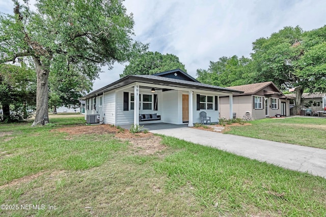 single story home featuring central AC unit and a front yard