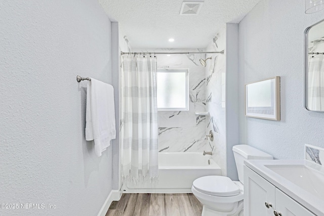 full bathroom featuring toilet, vanity, wood-type flooring, a textured ceiling, and shower / tub combo with curtain