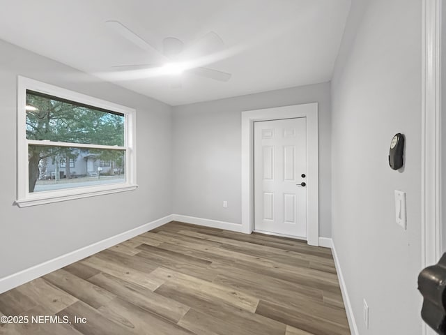 unfurnished room featuring hardwood / wood-style flooring and ceiling fan