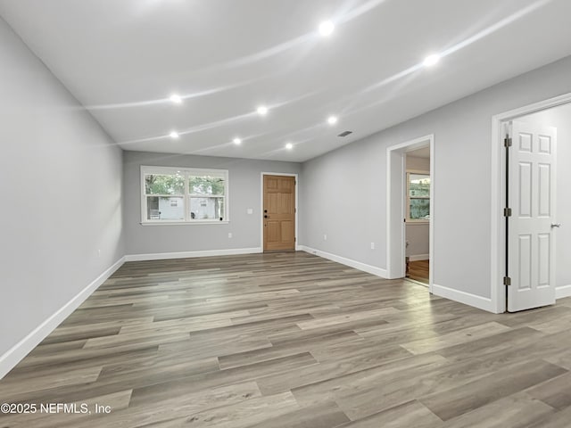 unfurnished living room featuring light hardwood / wood-style flooring and plenty of natural light