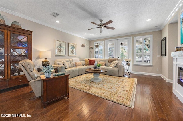 living room featuring a textured ceiling, crown molding, and dark hardwood / wood-style floors