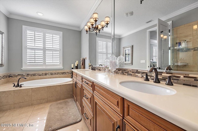 bathroom featuring independent shower and bath, tile patterned floors, ornamental molding, a chandelier, and vanity