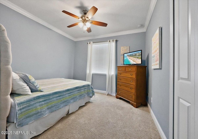 carpeted bedroom with ceiling fan and ornamental molding