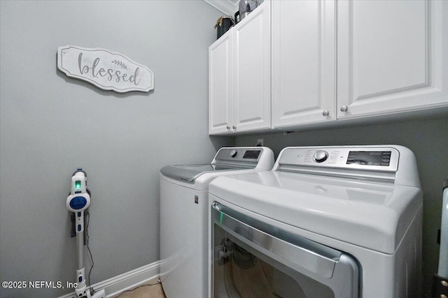 washroom featuring cabinets and washer and dryer