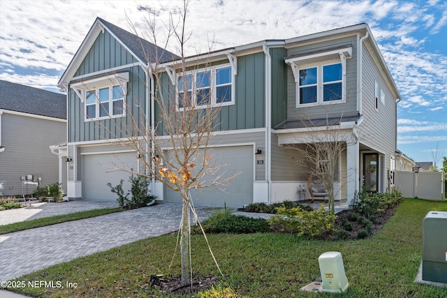 view of front of home with a garage and a front lawn