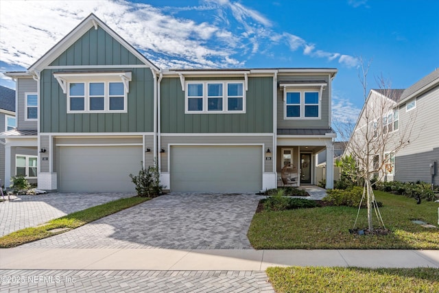 view of front of home with a garage and a front lawn