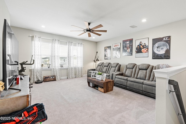 carpeted living room featuring ceiling fan