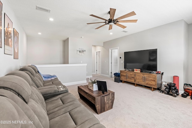 carpeted living room with ceiling fan