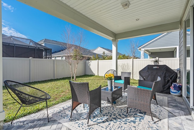 view of patio / terrace featuring area for grilling and glass enclosure