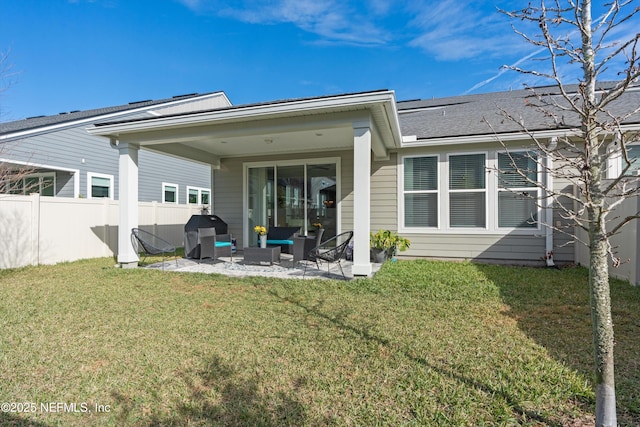 rear view of property featuring outdoor lounge area, a yard, and a patio area