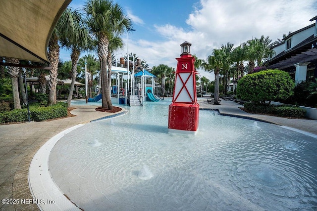 view of swimming pool with a playground