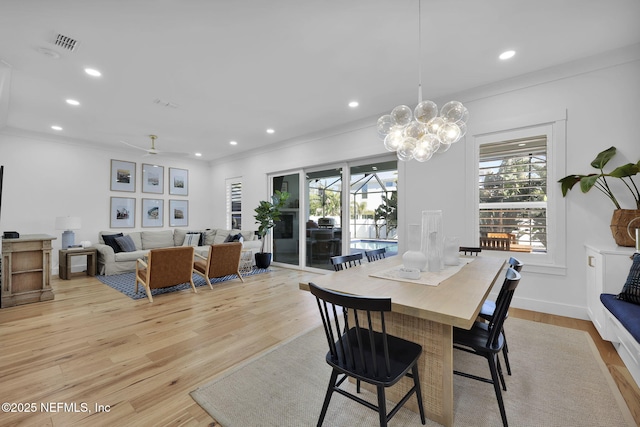 dining room with ceiling fan, crown molding, and light hardwood / wood-style floors