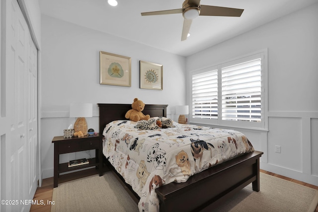 bedroom featuring ceiling fan, a closet, and light wood-type flooring