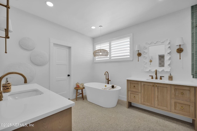 bathroom with a bath and vanity