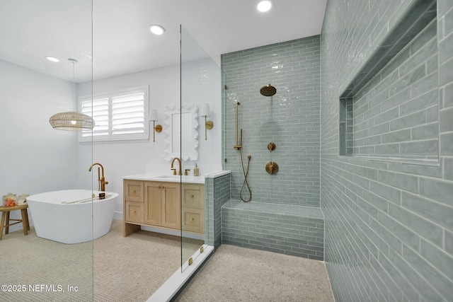 bathroom with vanity and independent shower and bath