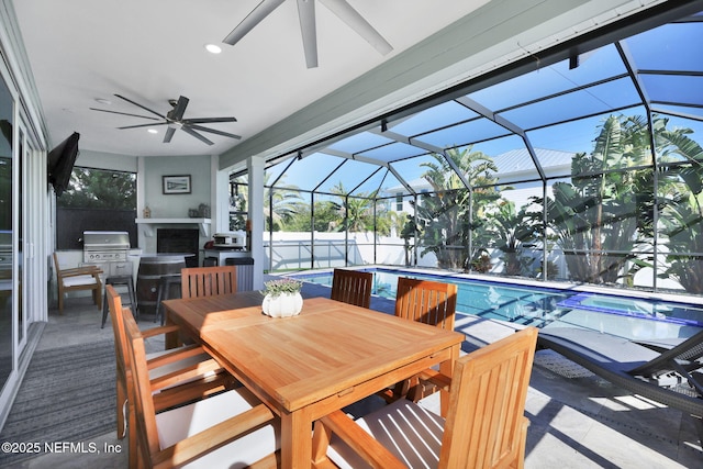 view of patio / terrace featuring a lanai, a fireplace, and a fenced in pool