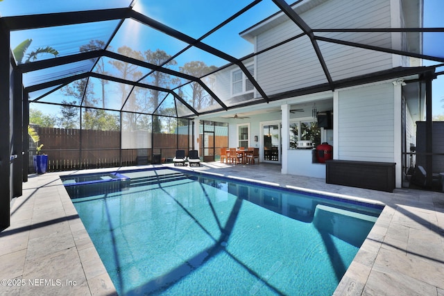 view of swimming pool with a lanai, ceiling fan, and a patio