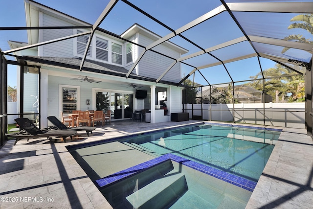 view of swimming pool with ceiling fan, an outdoor bar, a patio area, and glass enclosure