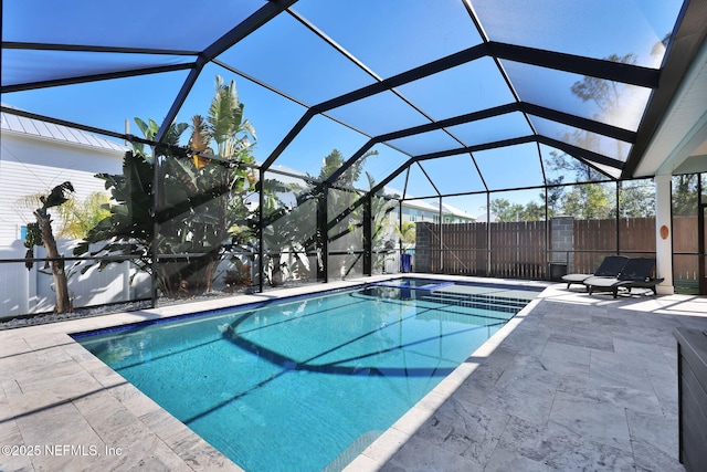 view of swimming pool with a lanai and a patio