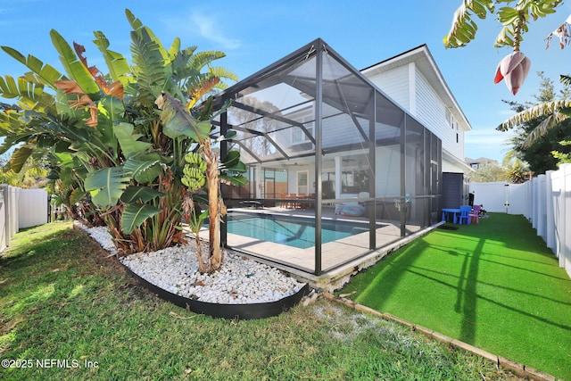 view of pool with a lanai, a lawn, and a patio